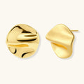 Gold sculptural stud earrings with flowing design