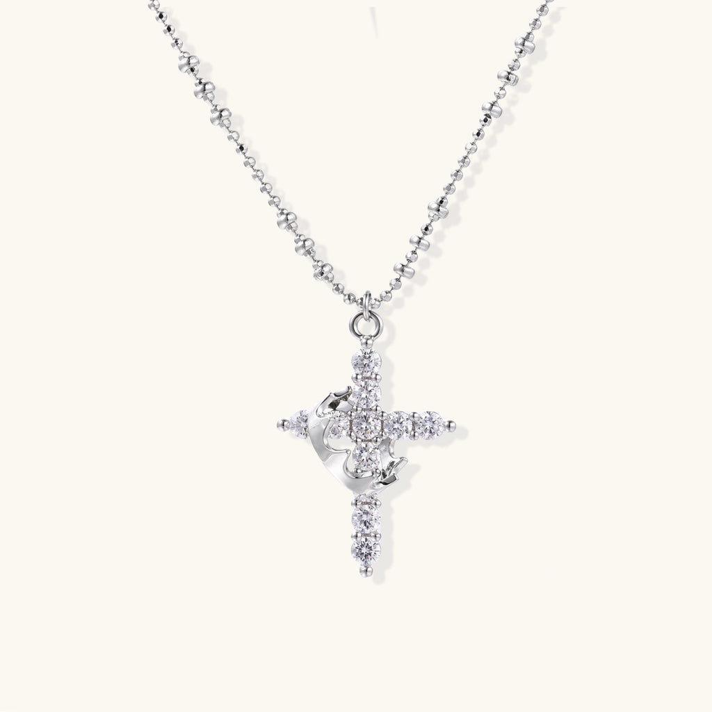 Gold cross pendant necklace on delicate chain