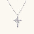 Gold cross pendant necklace on delicate chain