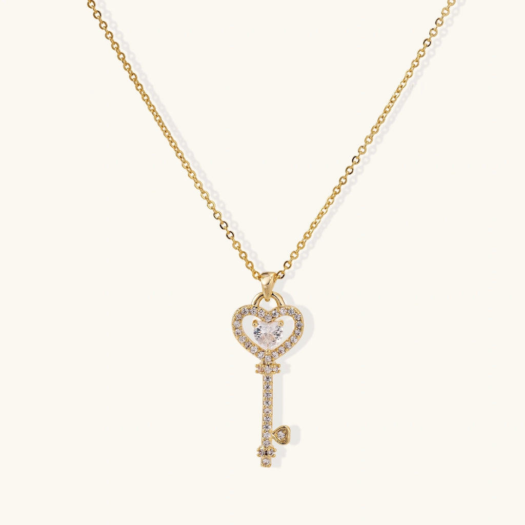 Gold heart and key pendant necklace on fine chain
