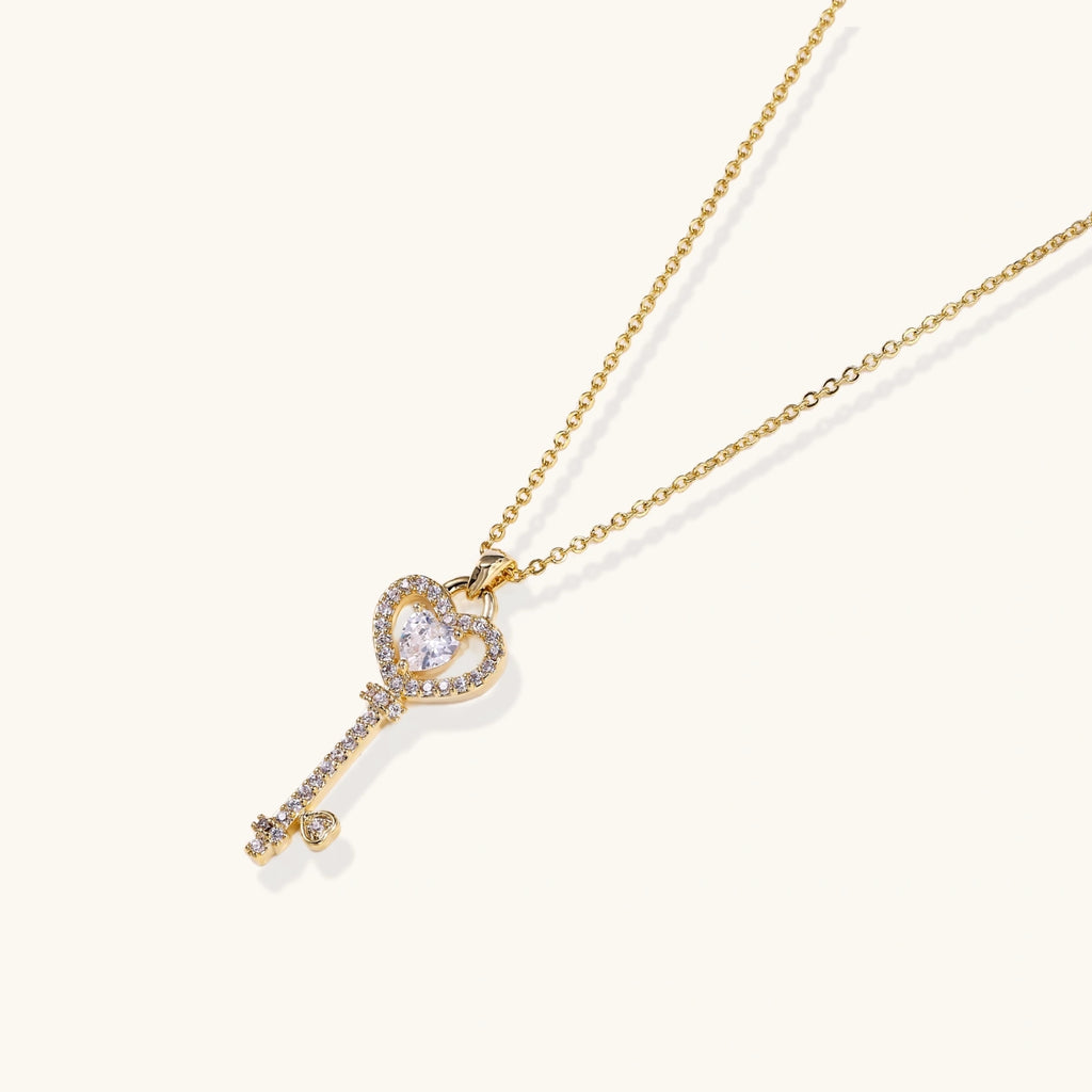Gold heart and key pendant necklace on fine chain