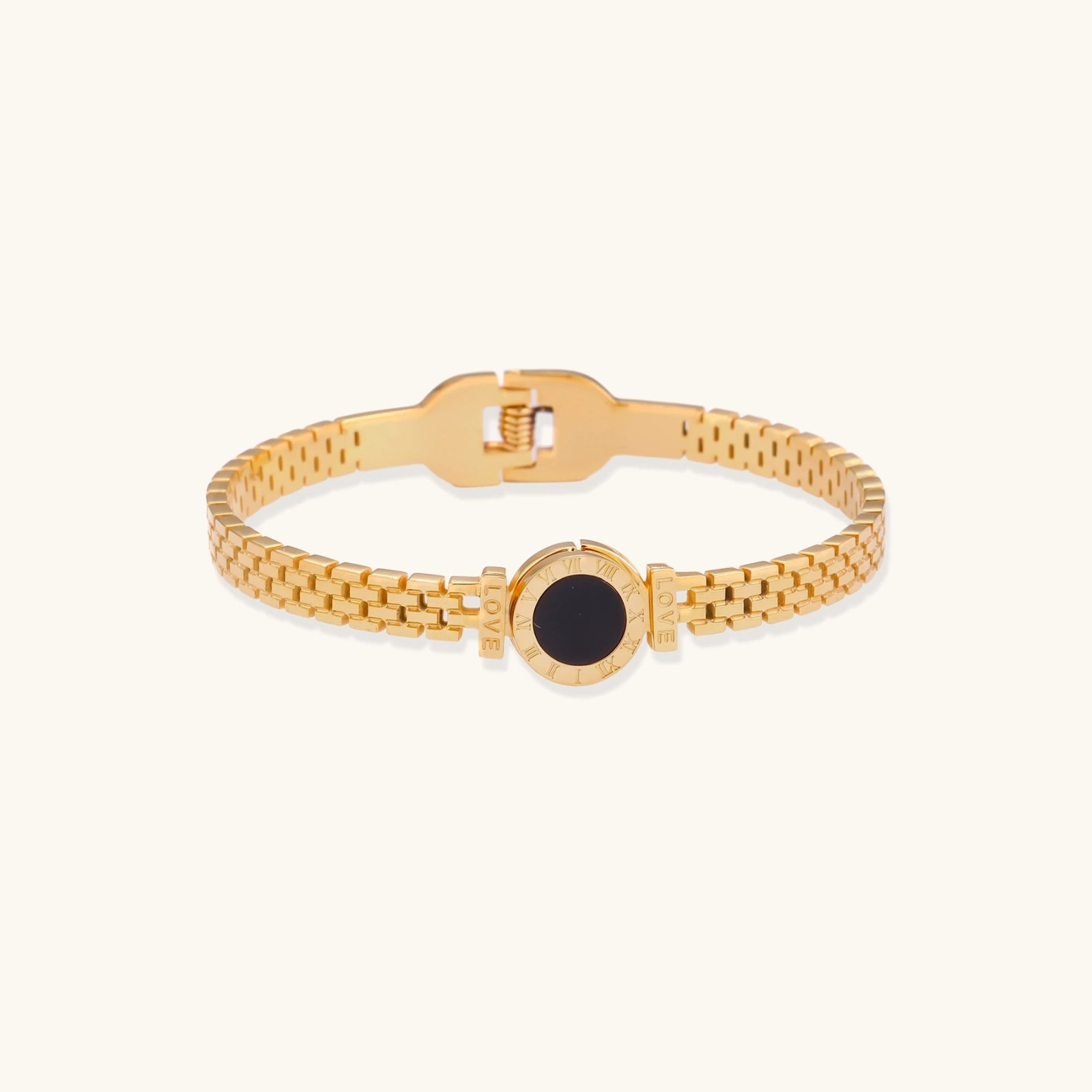 Gold bracelet with a black mother of pearl on a white background