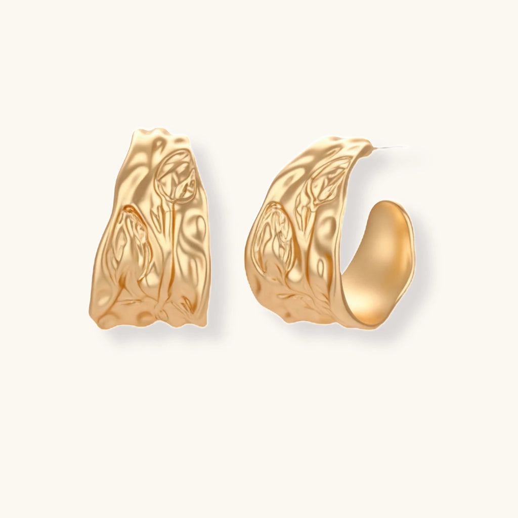 Close-up of textured hoop earrings with liquid metal ripple pattern in eco-zinc alloy with sterling silver posts.