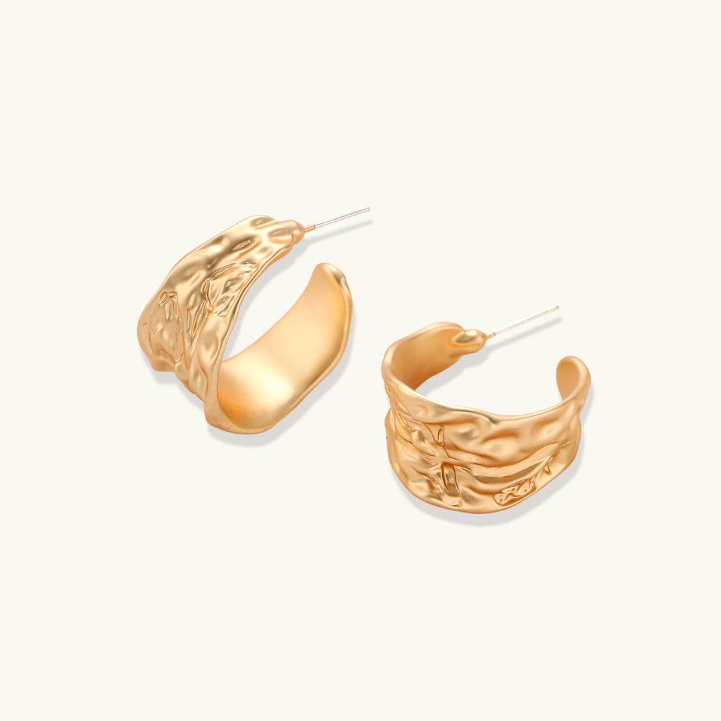 Close-up of textured hoop earrings with liquid metal ripple pattern in eco-zinc alloy with sterling silver posts.