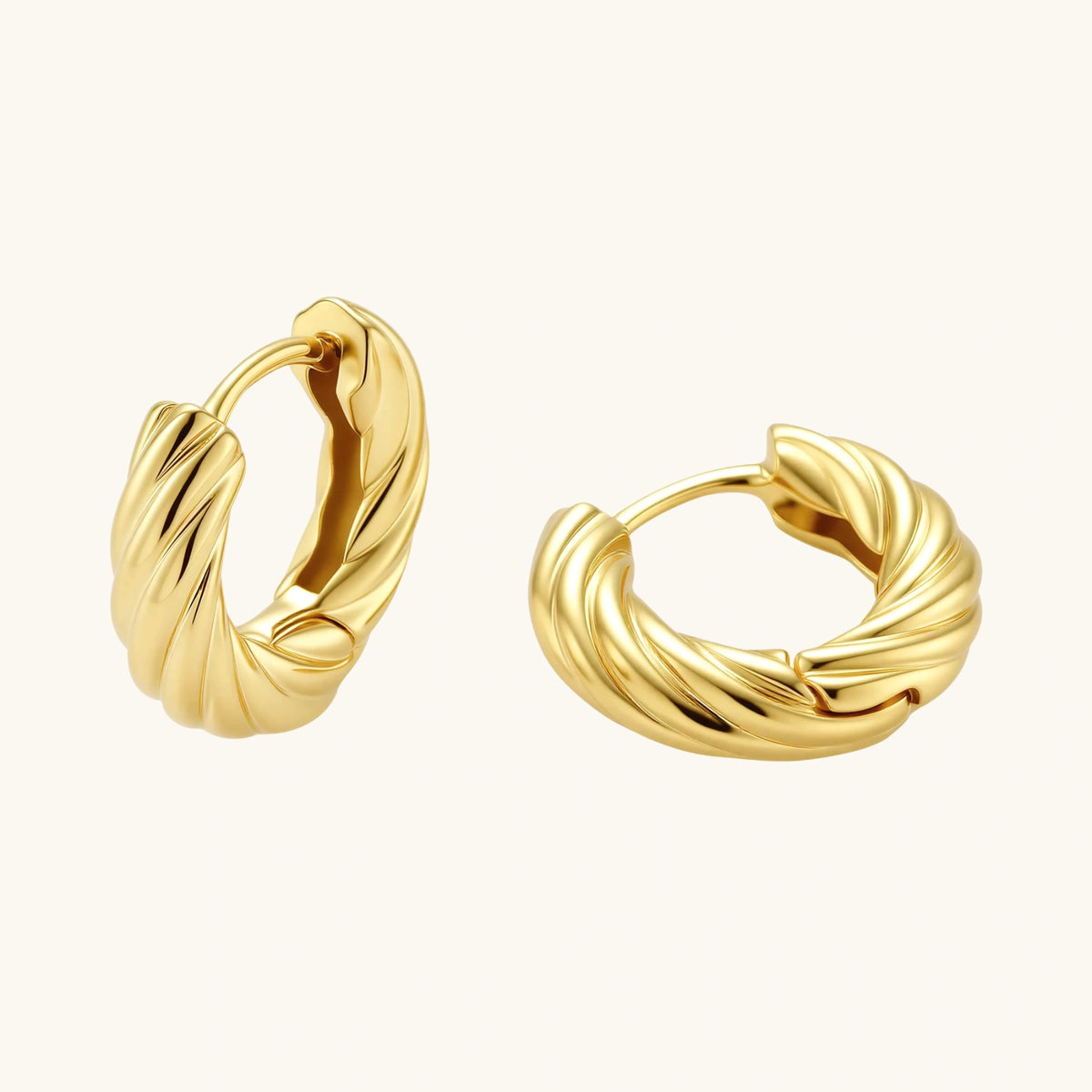 Pair of gold hoop earrings on a white background