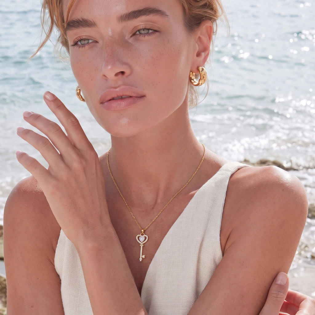 Gold heart and key pendant necklace on fine chain